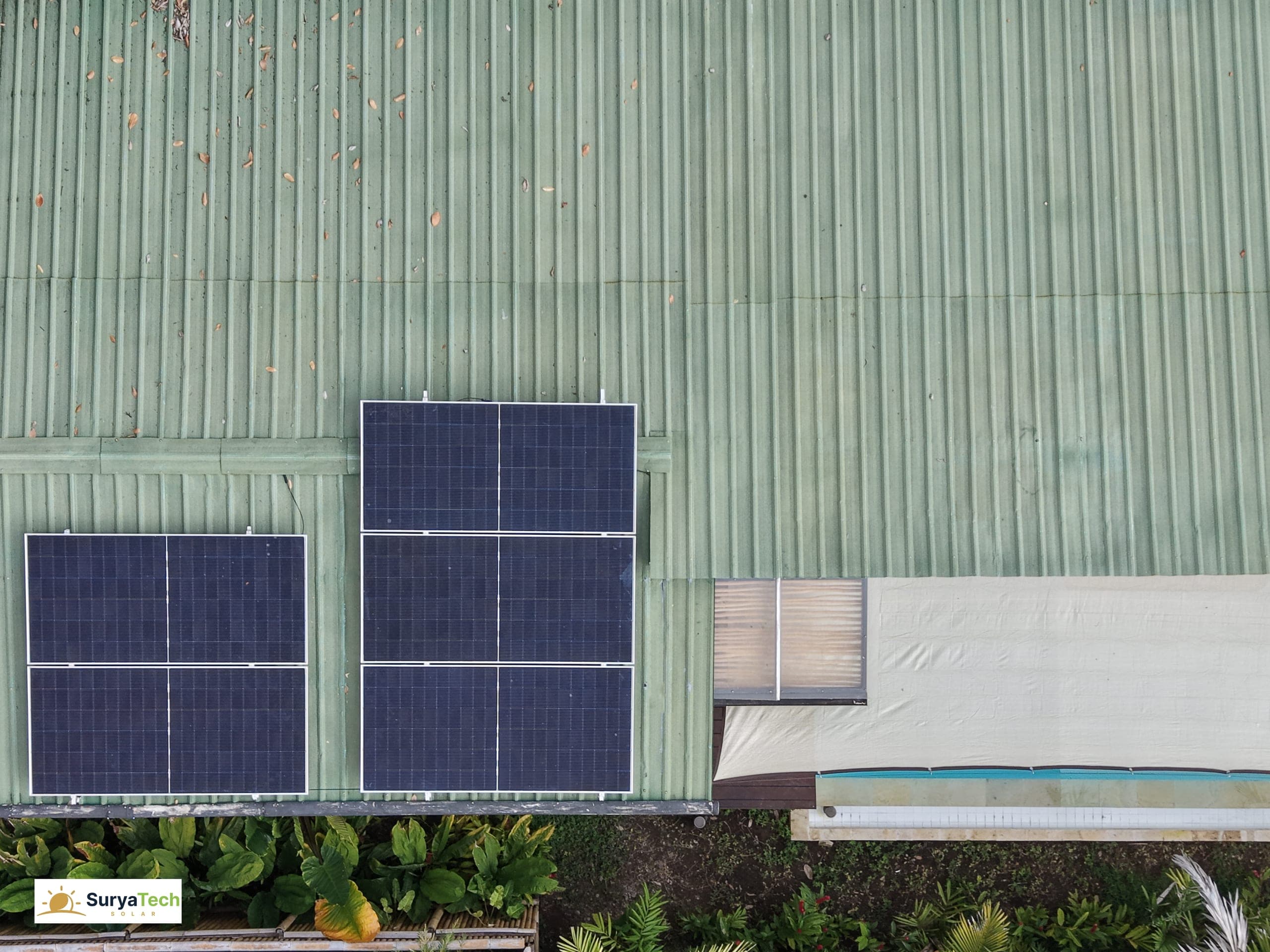 Ubud villa — close-up of the roof-mounted panels beside the pool deck